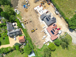 Interesting drone UAV view of a new detached bungalows being built within a small building plot in Cambridgeshire, UK. Established homes surround the site. © Nick Beer
