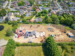 Interesting drone UAV view of a new detached bungalows being built within a small building plot in Cambridgeshire, UK. Established homes surround the site. © Nick Beer