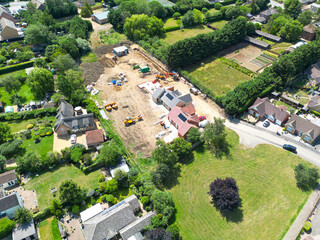 Interesting drone UAV view of a new detached bungalows being built within a small building plot in Cambridgeshire, UK. Established homes surround the site. © Nick Beer