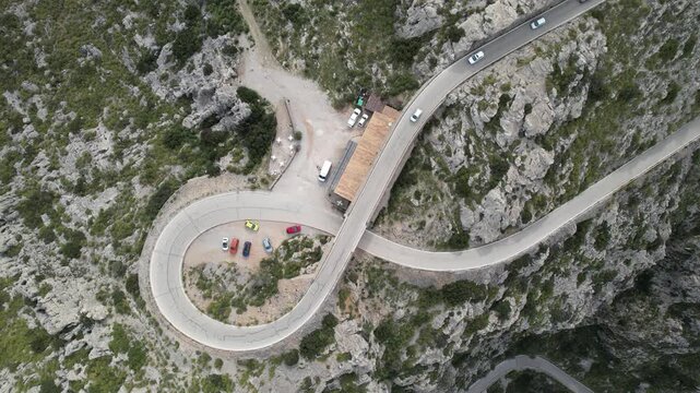 Aerial Top View of Winding Mountain Road Through Rocky Landscape