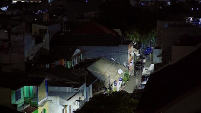 Overhead view of jakarta suburban kampung street at night with streetlight