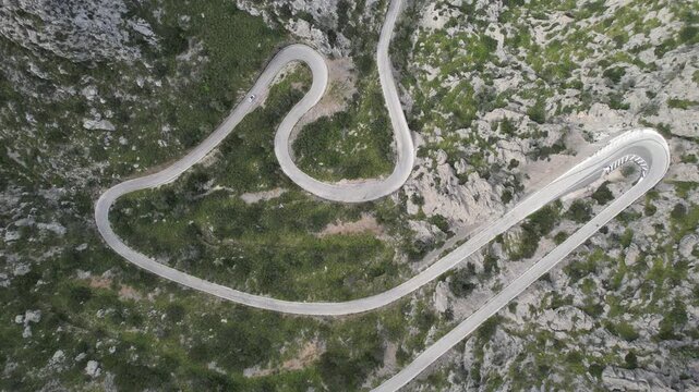 Aerial Top View of Winding Mountain Road Through Rocky Landscape