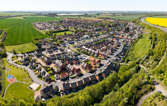 Aerial view of a new village in countryside with new build houses