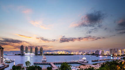 Fototapeta premium Twilight Coastal Cityscape with Yachts and Modern Towers