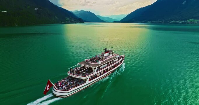Aerial view of steamboat ship in lake with Swiss Flag. Beautiful Swiss Alps nature in summer Switzerland with turquoise blue lake water