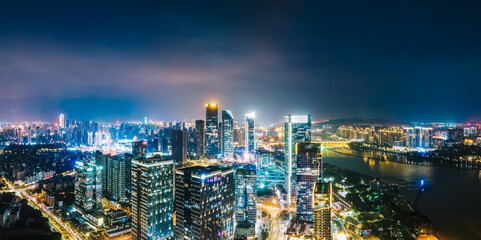 Obraz premium Panoramic Night View of Modern Urban Skyline with River