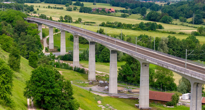 Railway viaduct over green valley in Germany, drone aerial view