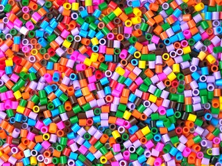 ​Colorful plastic perler beads background © Anastasiia