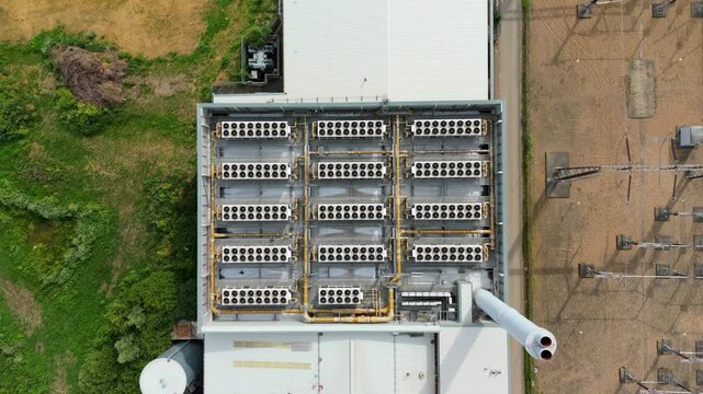 Top-down aerial view of industrial power station HVAC ventilation systems in rows for mechanical cooling, Hoddesdon, UK.