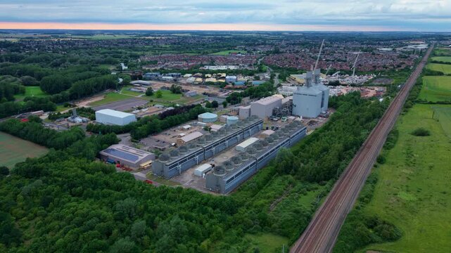 High aerial view of a gas turbine power plant showing massive industrial air cooled condenser units, England.
