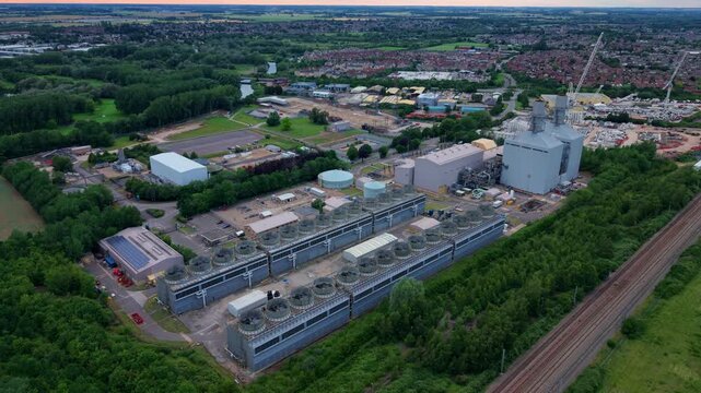 High aerial view of a gas turbine power plant showing massive industrial air cooled condenser units, England.