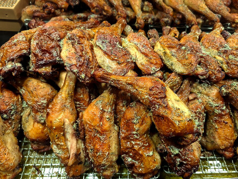 A large pile of roasted or grilled chicken leg quarters
