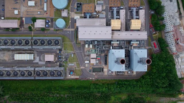High aerial view of a gas turbine power plant showing massive industrial air cooled condenser units, England.