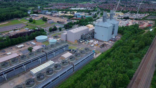 Aerial view of a large energy production power plant with rows of rotating turbines visible on the generation house roof in Bedfordshire, UK.