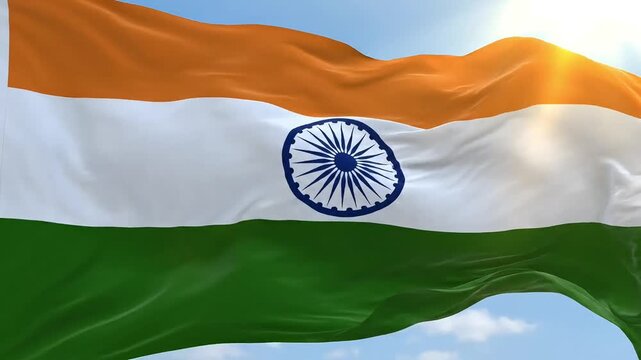 Vibrant Indian flag waving majestically against a bright blue sky with sun flares