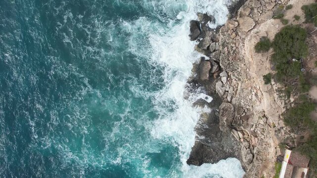 Aerial View of Natural Rock Arch Over Blue Sea on Dramatic Coastal Cliffs