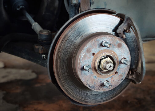 Rusty and worn car brake disc rotor needing repair