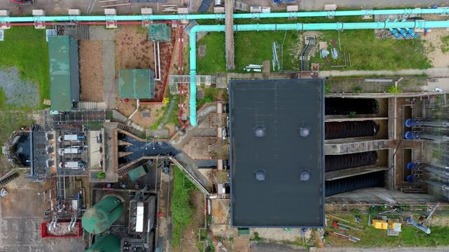 Aerial view of a massive Archimedes screw pump lifting wastewater at a sewage treatment works for urban sanitation, Milton Keynes, UK.
