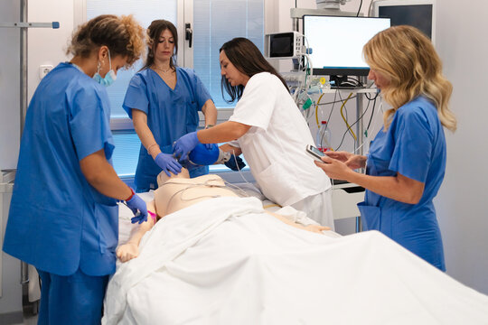 Nurses practicing resuscitation during medical training simulation