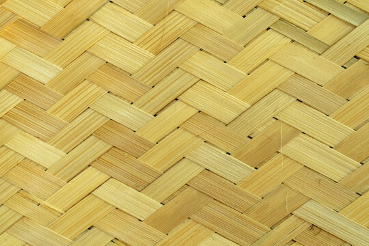 Traditional woven bamboo pattern with natural beige tones, creating a handcrafted texture suitable for backgrounds, interior design, and architectural concepts.