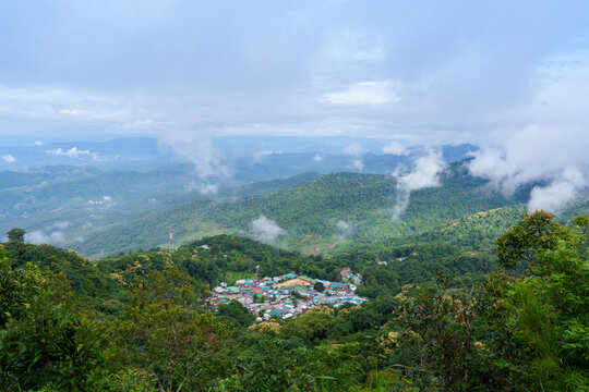Mountain village with green forest and misty clouds. Doi Pui Hmong Ethnic Hill-tribe Village area creating peaceful nature in Chiang Mai Thailand