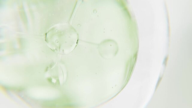 Cosmetics green serum liquid bubble 3d abstract background. Cosmetic moisturizer essence gel. Collagen fluid bubble molecule. Moisturizing cream or oil. Personal health care and beauty skin concept