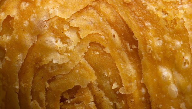 Close-up Texture of Golden Flaky Curry Puff Pastry,Macro,A detailed macro shot highlighting the golden, crispy, and intricate flaky layers of a freshly baked curry puff pastry, showcasing.