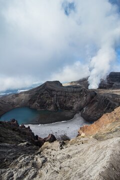 Steaming fumarole with crater lake on the Gorely volcano, Kamchatka, Russia