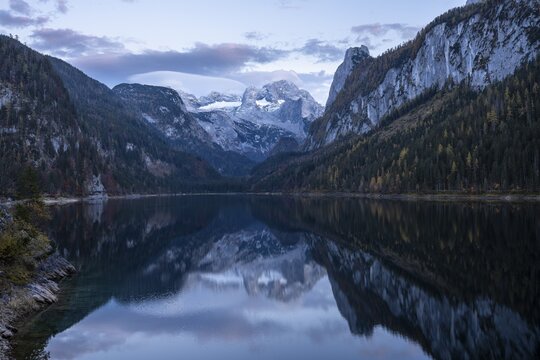The Vordere Gosausee lake in autumn with a view of the Dachstein mountain range. The Gosaukamm on the right. Good weather, blue sky. Few clouds. In the evening, after sunset. Reflection. Vorderer Gosausee, Gosau, Gosau valley, Salzkammergut, Upper Austria, Austria