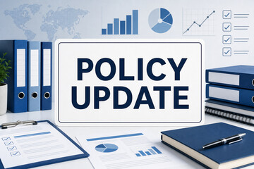 Obraz premium Office desk scene with policy update sign, binders, charts, checklists, and documents in a professional blue corporate setting.