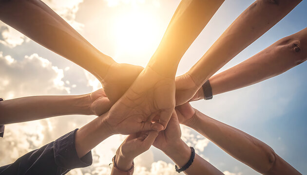 Diverse group of people joining hands in a circle, symbolizing unity, teamwork, and community, with bright sunlight and clouds in the background, celebrating togetherness and cooperation