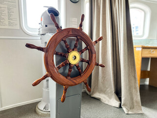 Wooden ship wheel inside of captain cabin © Krievietka
