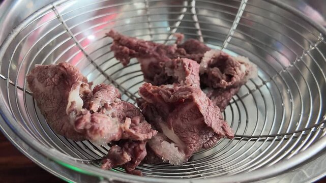 fresh blanched beef ingredients placed in a colander