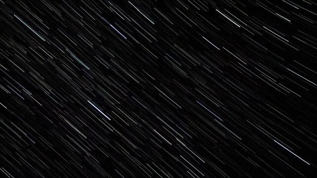 Abstract star trails create a dynamic pattern across the dark night sky
