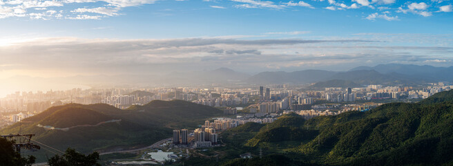Obraz premium Panoramic valley and city sprawl under clear midday sky Sanya, Hainan Island, China