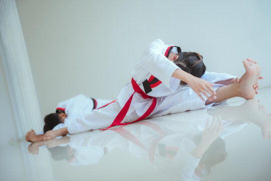 Kids practice taekwondo moves in training session at a martial arts dojo during afternoon class