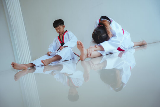 Kids practice taekwondo moves in training session at a martial arts dojo during afternoon class