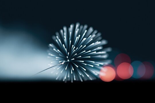 Colorful lights and glowing sparks create a festive mood in the night sky during a celebration
