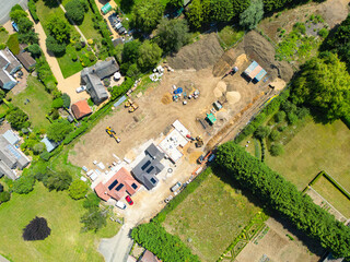 Interesting drone UAV view of a new detached bungalows being built within a small building plot in Cambridgeshire, UK. Established homes surround the site. © Nick Beer