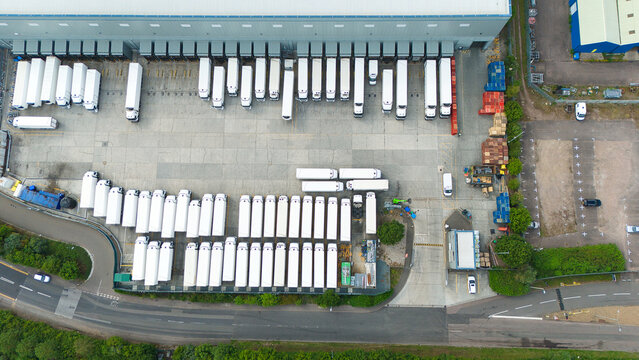 Top-Down Aerial View of Trucks and Lorries Parked at Distribution Center Loading Bays