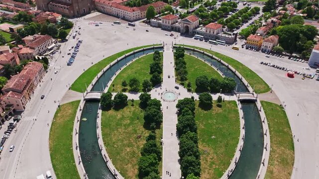Aerial drone view of Prato della Valle in Padua (Padova), Italy, showcasing the iconic elliptical square, surrounding statues, canals, and historic architecture in Veneto