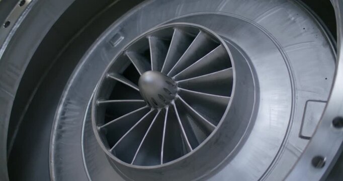 Close up view of a metallic radial turbine fan assembly inside an industrial machine housing