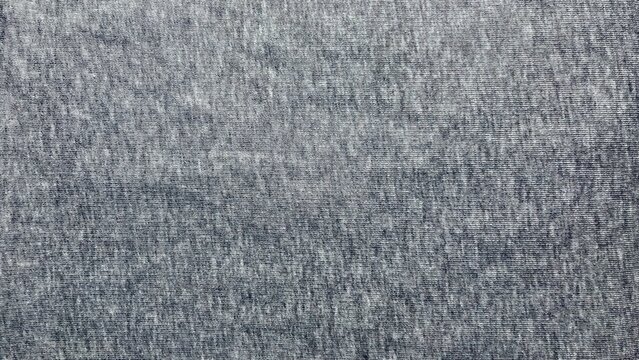 heather gray fabric texture reveals organic jersey weave detail in minimal flat lay composition evoking cozy wellness comfort