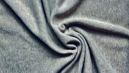 organic gray cotton jersey fabric background with swirled soft folds creates a serene minimalist textile texture © Arthur