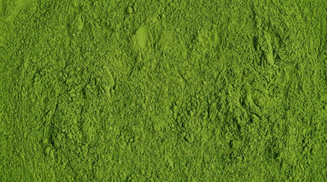 Solid vibrant green matcha tea powder texture background