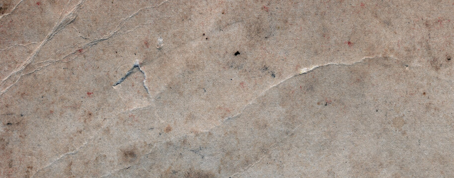 Weathered paper texture with visible fibers, cracks, torn surface areas and pronounced signs of aging in panoramic format.