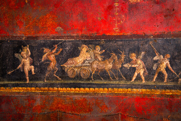 Ancient Roman fresco wall paintings of Dionysian frieze with winged cupids from Pompeii, Campania, Italy, Europe © Naya Na