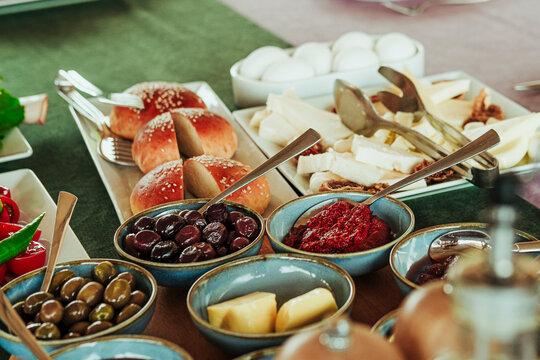 traditional turkish breakfast feast with rich variety on table photos series, fried dough pisi, green herbs, watermelon, cheese plate