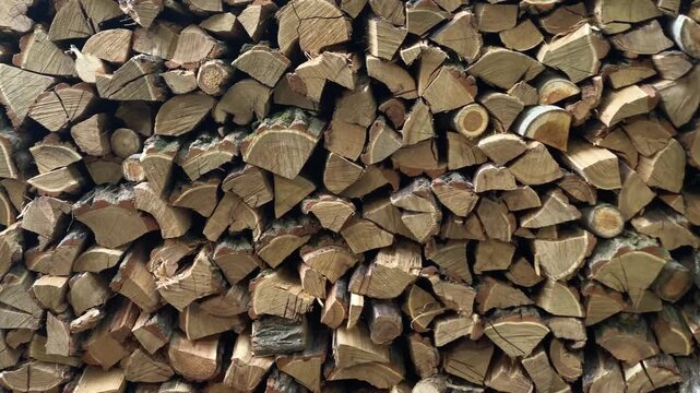 Stacked chopped firewood background in a woodshed