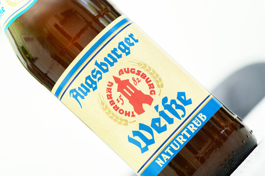 Iserlohn, Germany - May 29, 2026: Close up of an Augsburger Weisse beer bottle label with brewery branding and wheat imagery